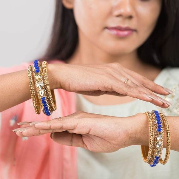 Metal with Zircon Gemstones Glossy Finished Gold & Blue Color Bangles Set together in two hands